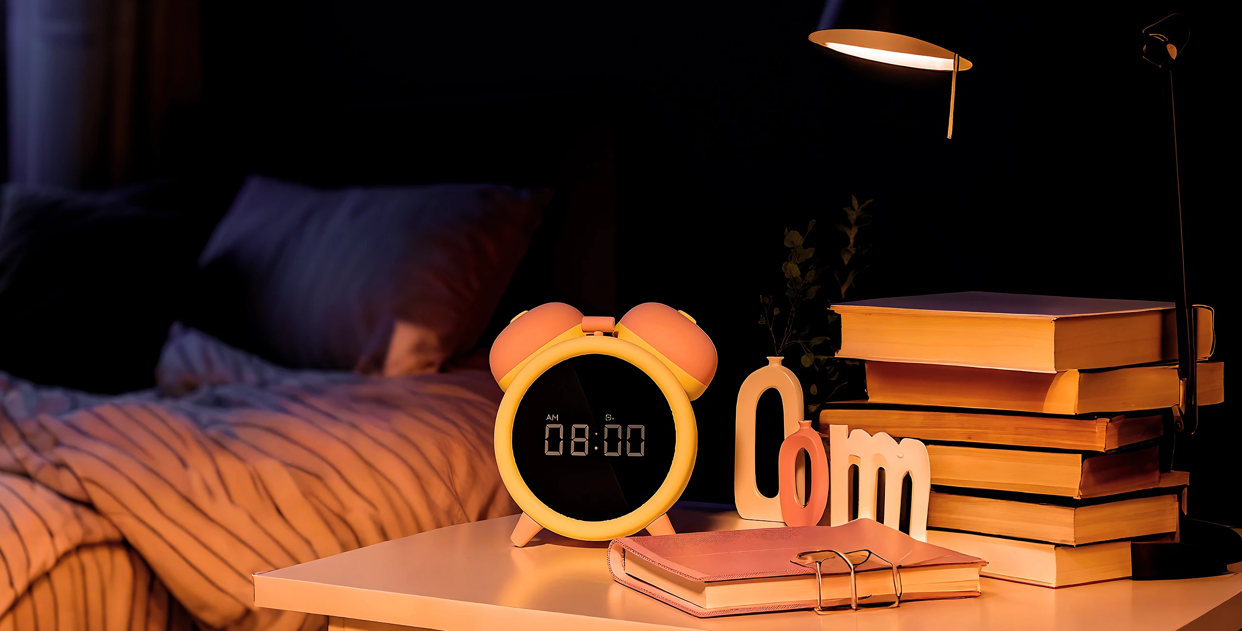Luxury vibrating alarm clock with discreet dual stimulators hidden in retro design, placed on bedside table in warm-lit bedroom