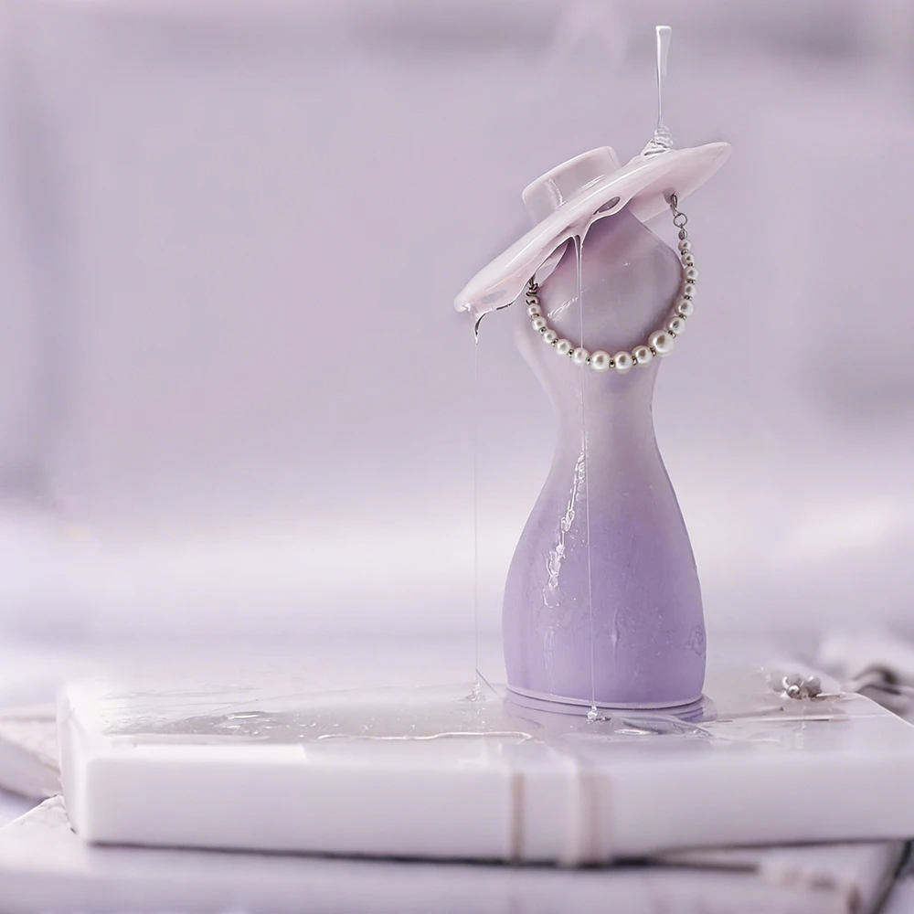 TAOF Protagonist artistic product shot featuring the lavender sculpture, pearl necklace, and silky lubricant dripping seamlessly from the suction port onto a marble base.